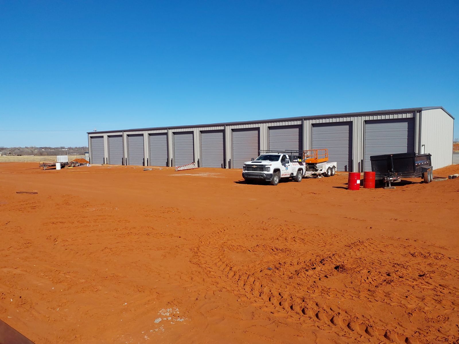 Commercial storage facility with a full row of overhead doors installed by Redneck Doors