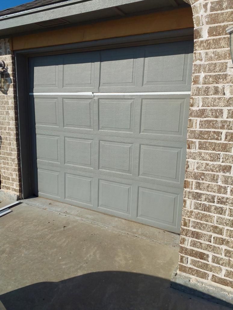 Garage door with failing, damaged panels before replacement