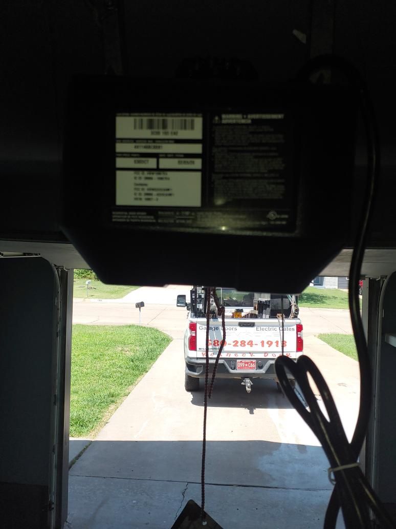 Garage door opener service call with the Redneck Doors truck outside