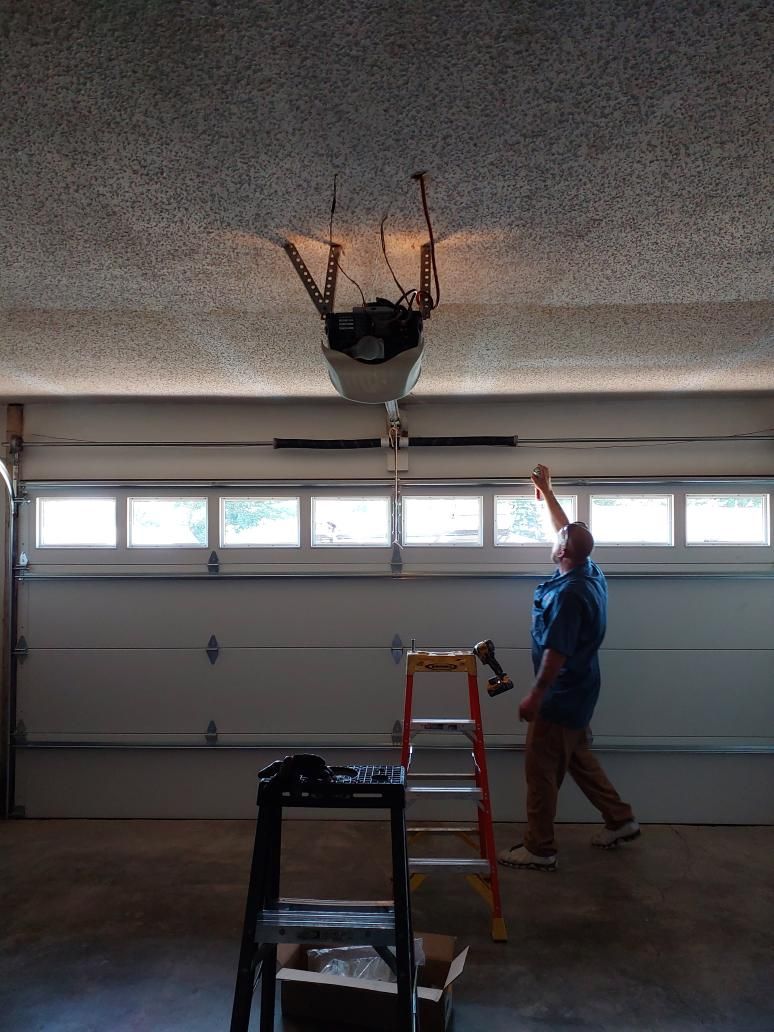 Redneck Doors technician repairing a garage door